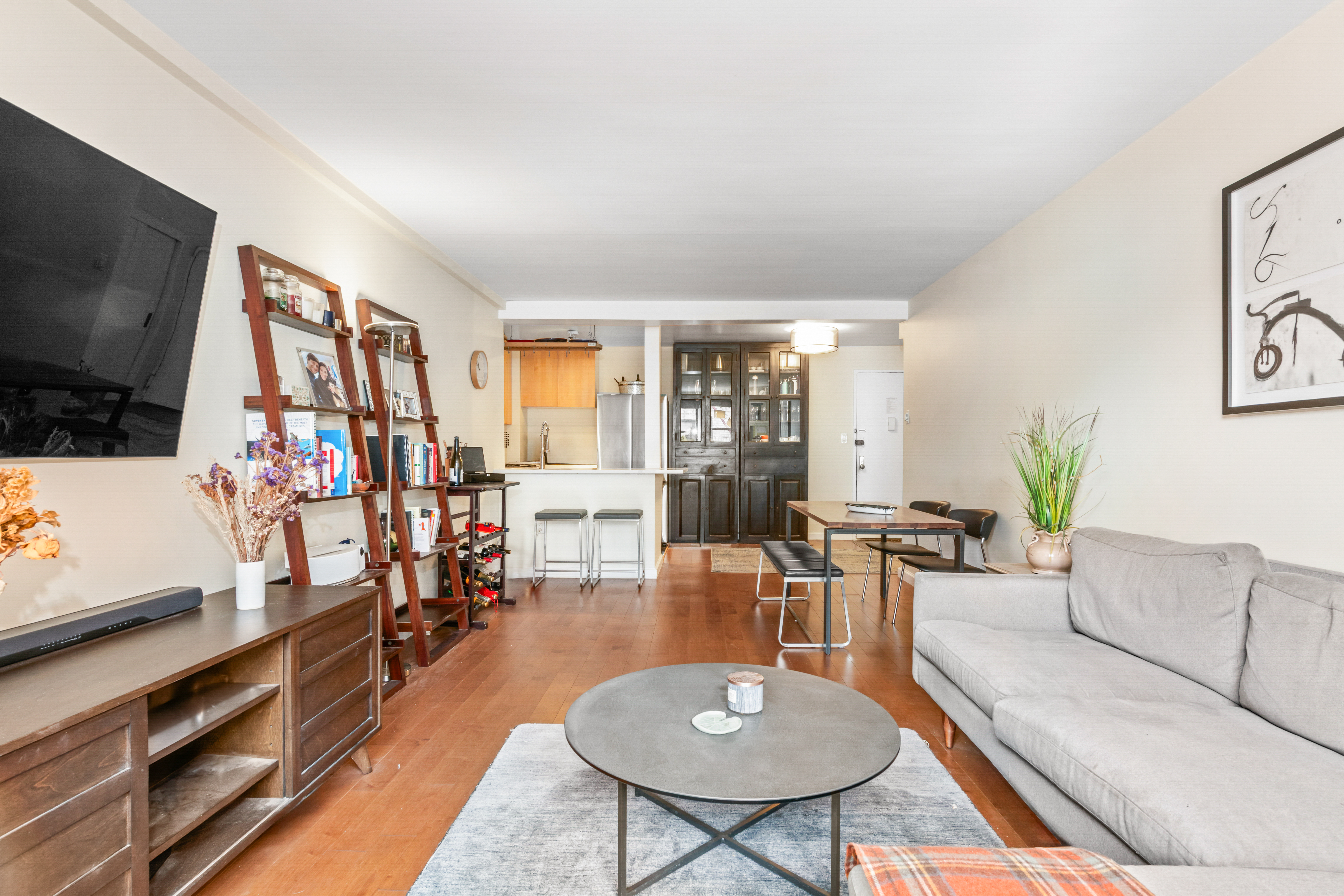 165 Christopher Street, Unit 5AA Manhattan, NY 10014 - Photo 2 of 9 a living room with furniture and a flat screen tv