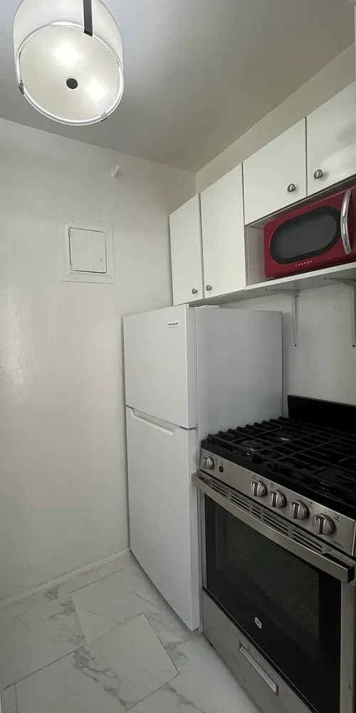 a view of a balcony with two chairs and a table