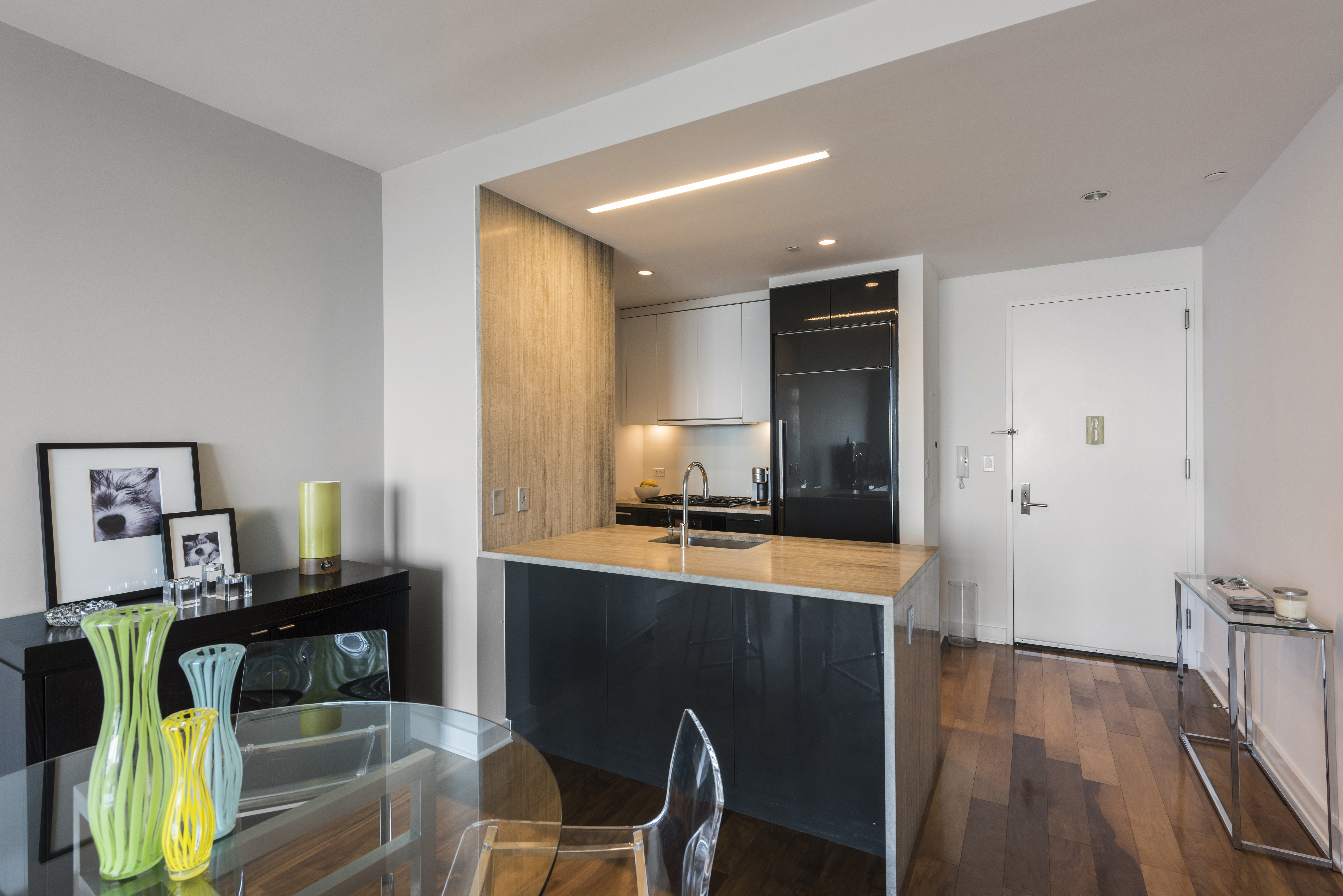 2 Northside Piers, Unit 20C Brooklyn, NY 11249 - Photo 4 of 12 a room with wooden floor table and furniture