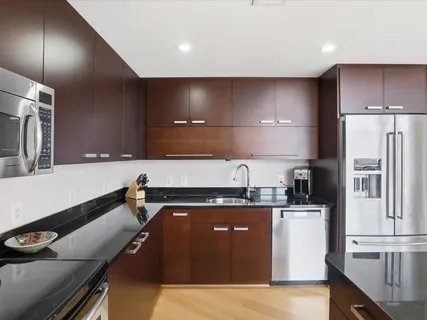 a kitchen with a sink appliances and cabinets