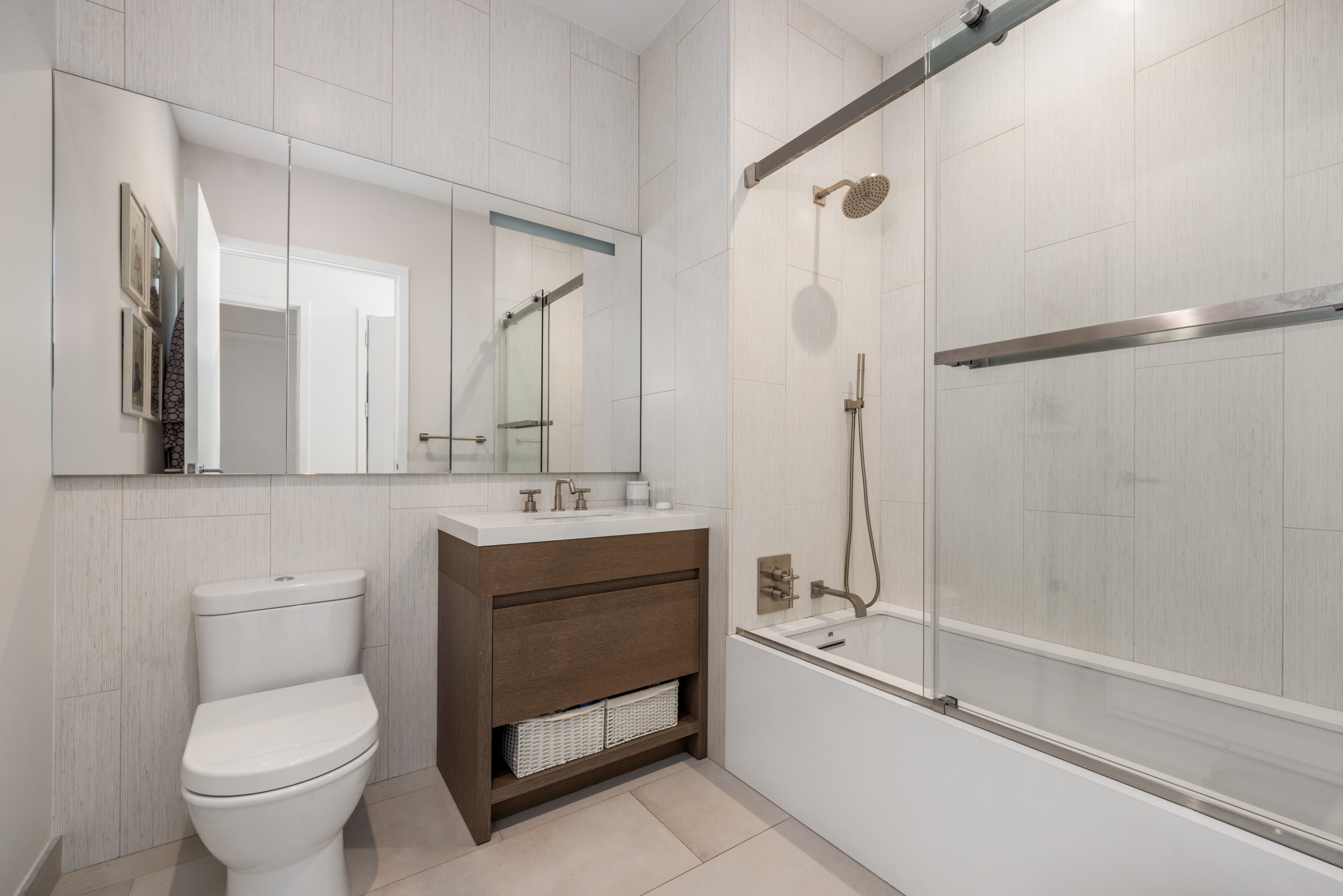 360 East 89th Street, Unit 29B Manhattan, NY 10128 - Photo 12 of 22 a bathroom with a sink toilet and shower