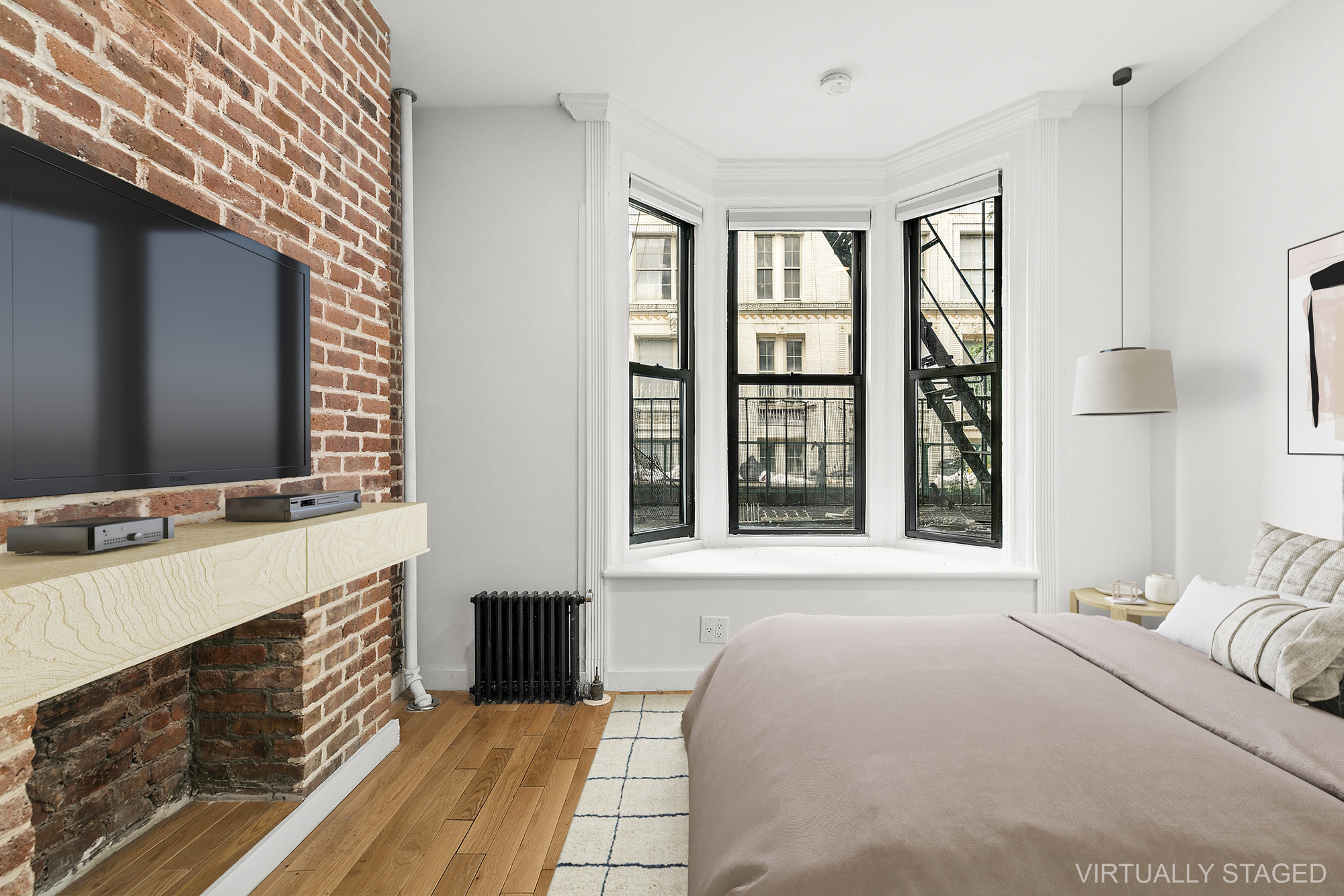 75 Pineapple Street, Unit 2A Brooklyn, NY 11201 - Photo 3 of 6 a bedroom with a bed table and a flat screen tv