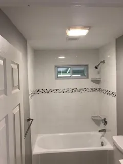 a bathroom with a bathtub and a shower