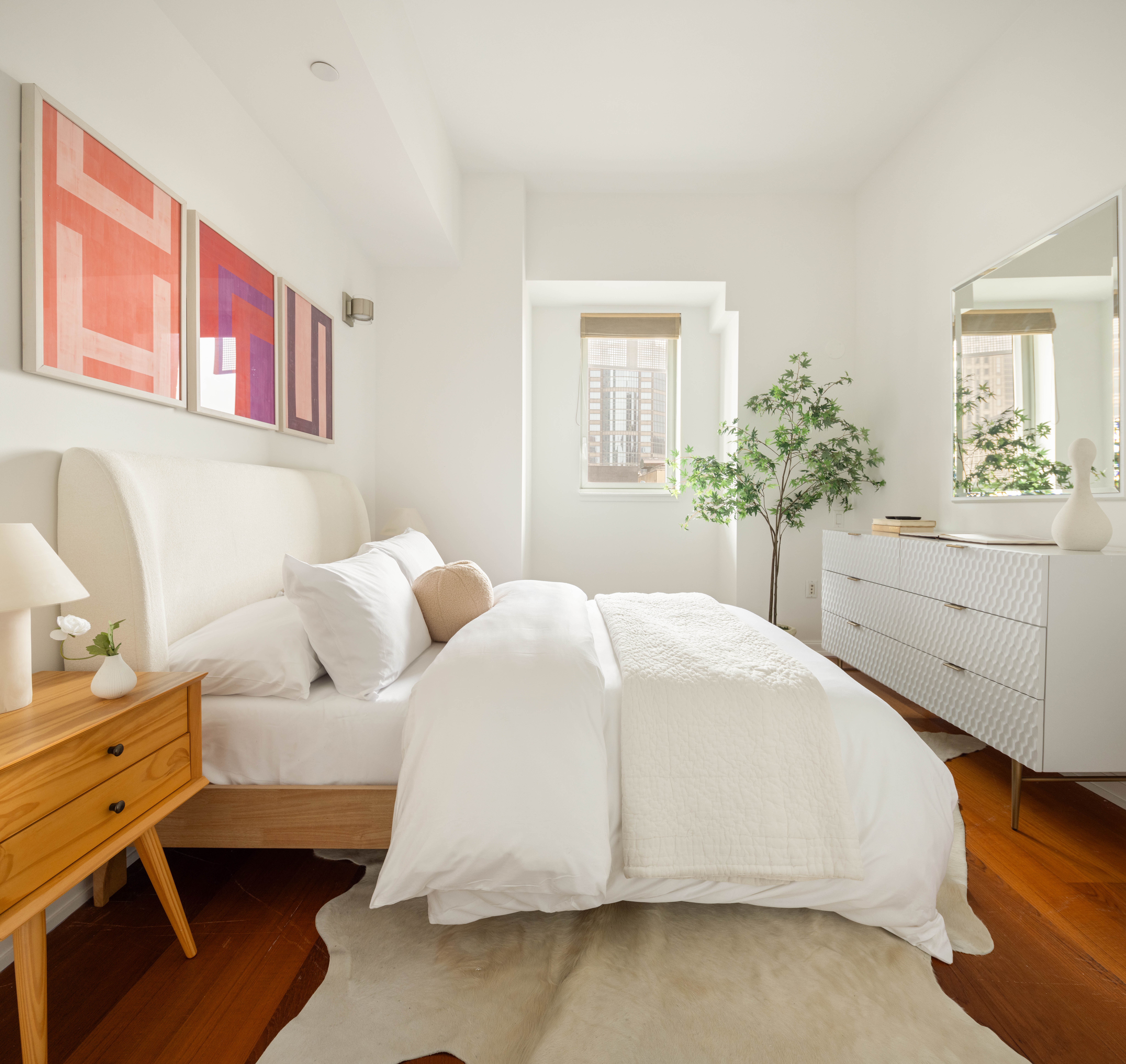 205 East 59th Street, Unit 14B Manhattan, NY 10022 - Photo 7 of 19 a bedroom with a bed and a dresser