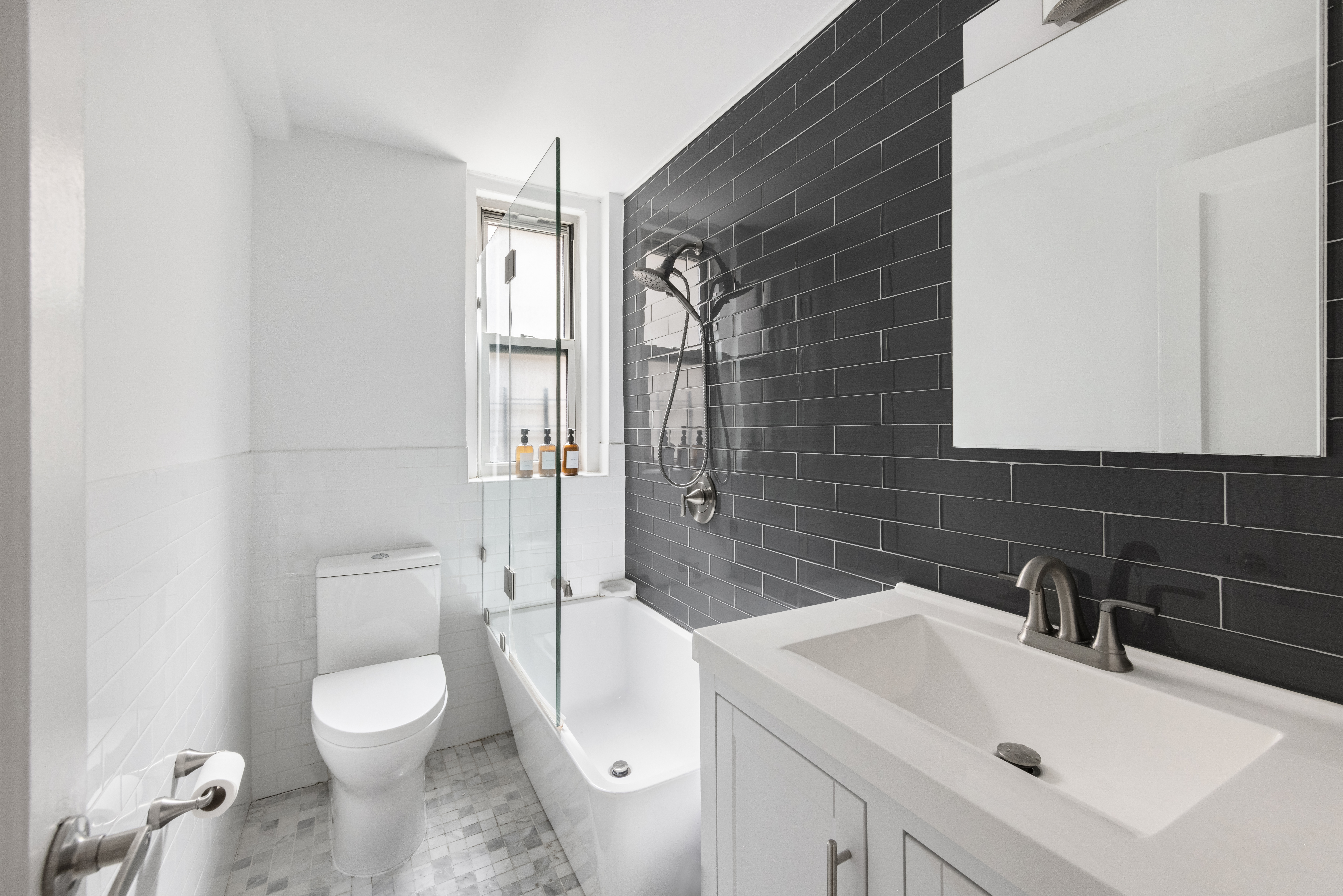 425 East 86th Street, Unit 2F Manhattan, NY 10028 - Photo 6 of 11 a bathroom with a toilet sink shower and mirror