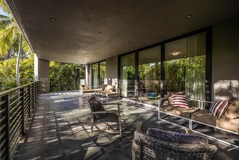 a sitting area with furniture and wooden floor
