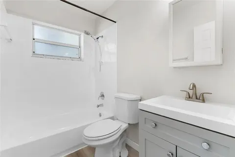 a bathroom with a sink toilet and vanity