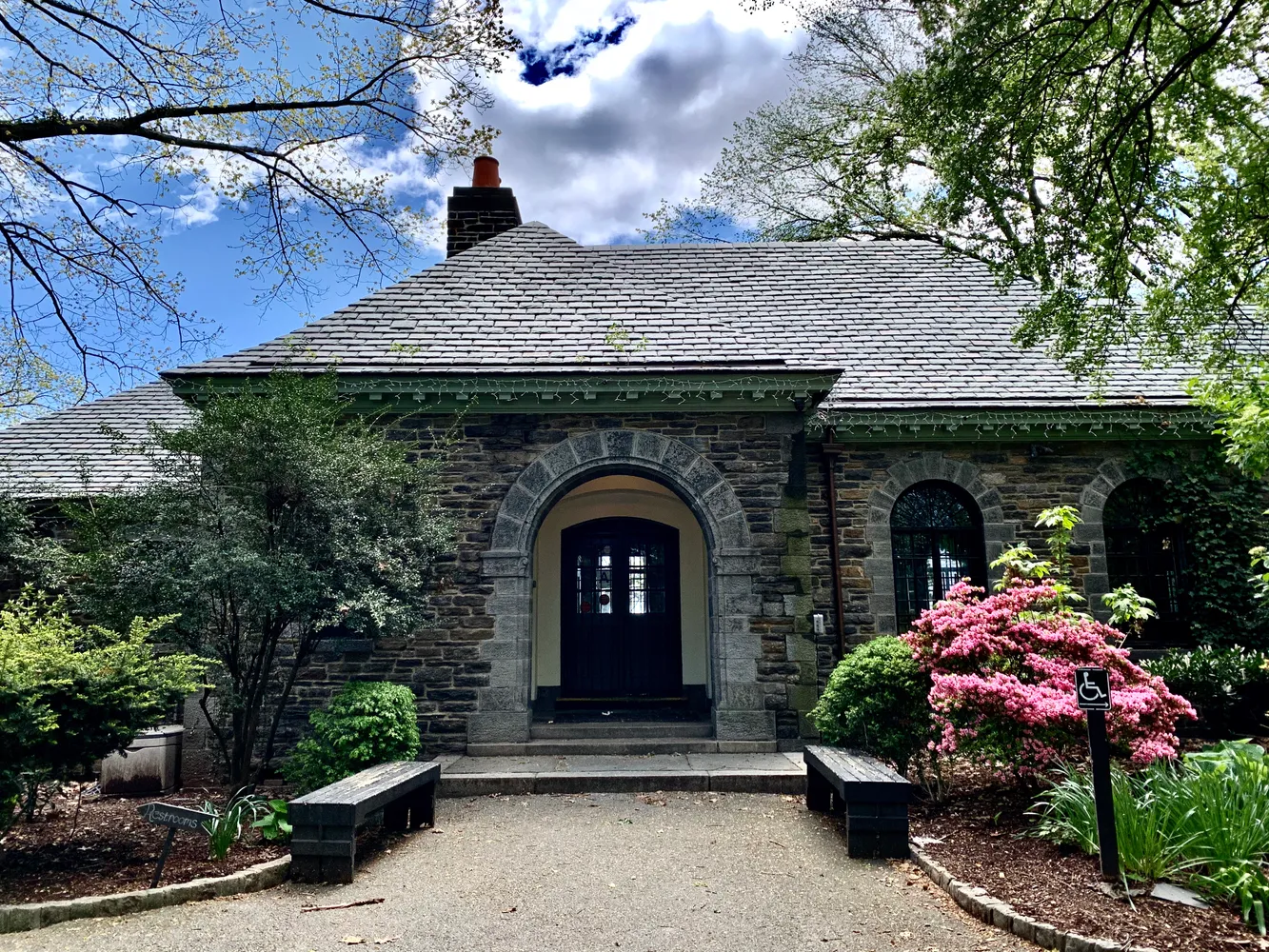 a front view of a house with plants