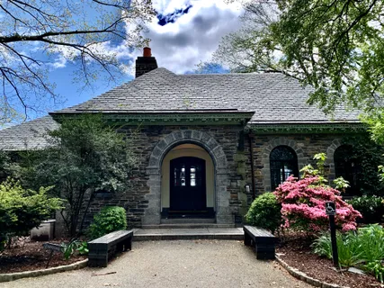 a front view of a house with plants