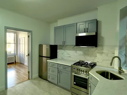 a kitchen with stainless steel appliances a stove a microwave sink and refrigerator