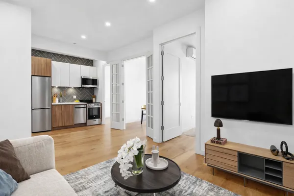 a living room with furniture and a flat screen tv