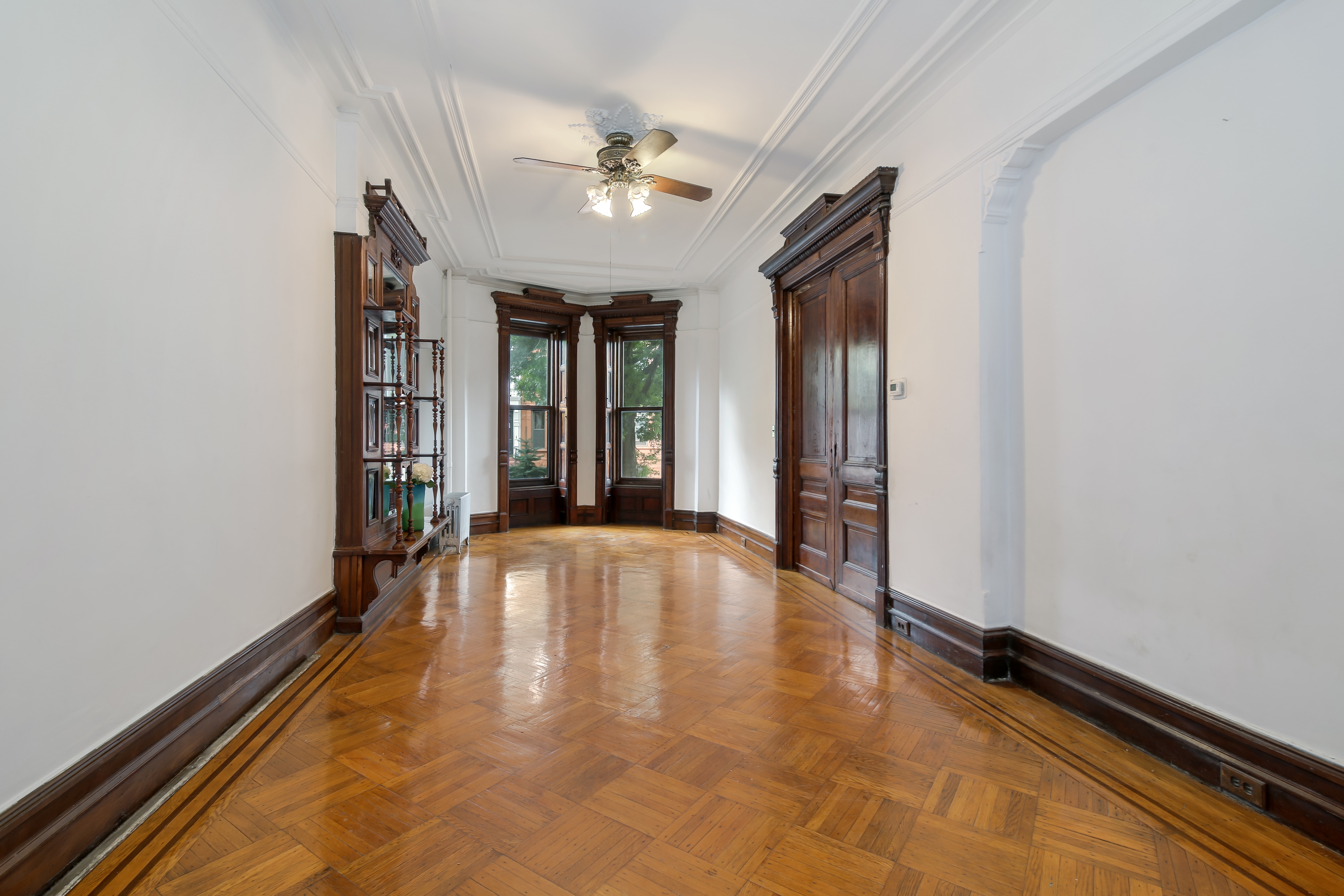 666 Putnam Avenue, Unit 1 Brooklyn, NY 11221 - Photo 3 of 8 wooden floor in an empty room with a window