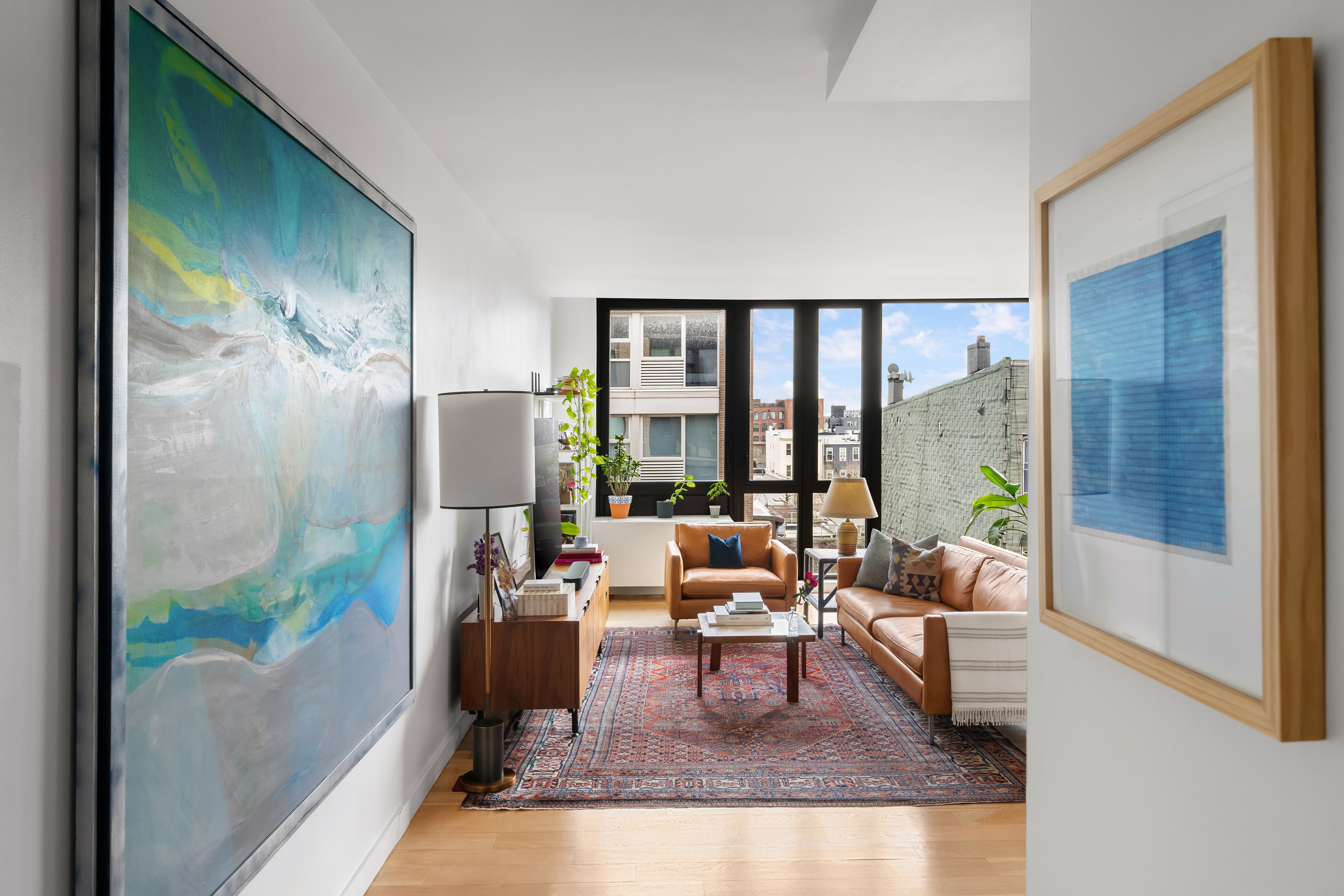 70 Berry Street, Unit 5G Brooklyn, NY 11249 - Photo 2 of 10 a living room with furniture and a floor to ceiling window
