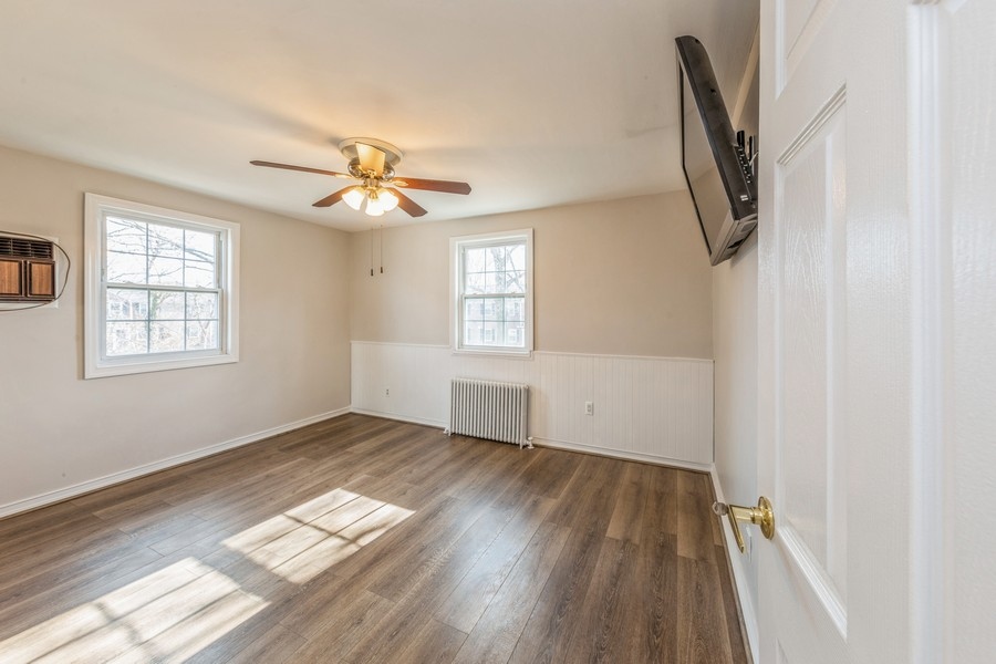 224-46 Horace Harding Expressway, Unit 630 Queens, NY 11364 - Photo 12 of 29 wooden floor in an empty room with a window