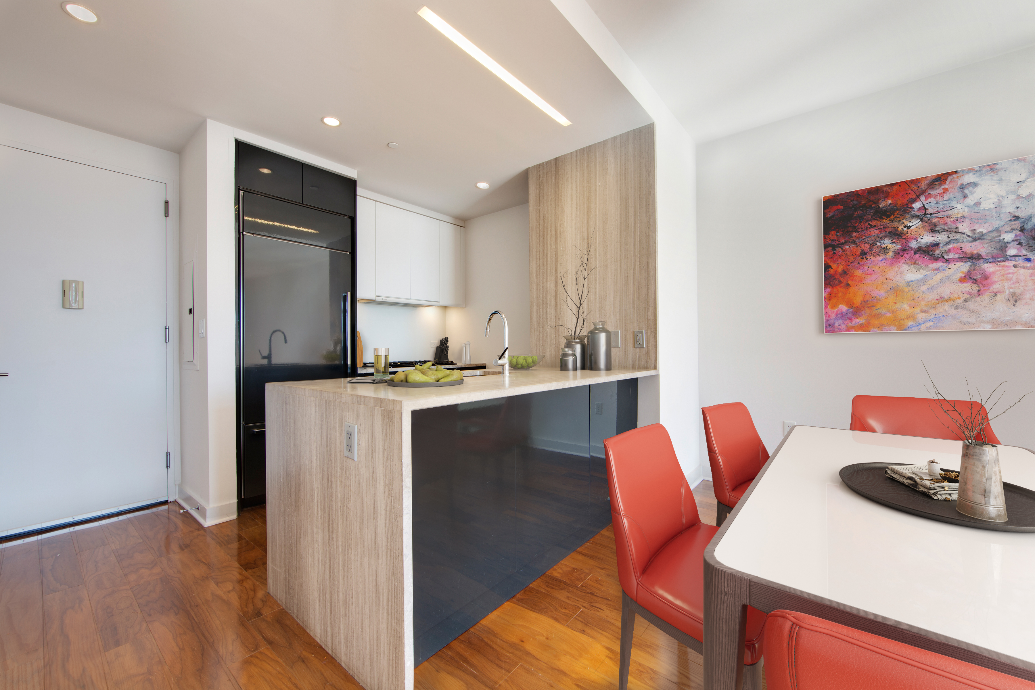2 Northside Piers, Unit 21B Brooklyn, NY 11249 - Photo 2 of 11 a kitchen with stainless steel appliances granite countertop a table chairs and a refrigerator