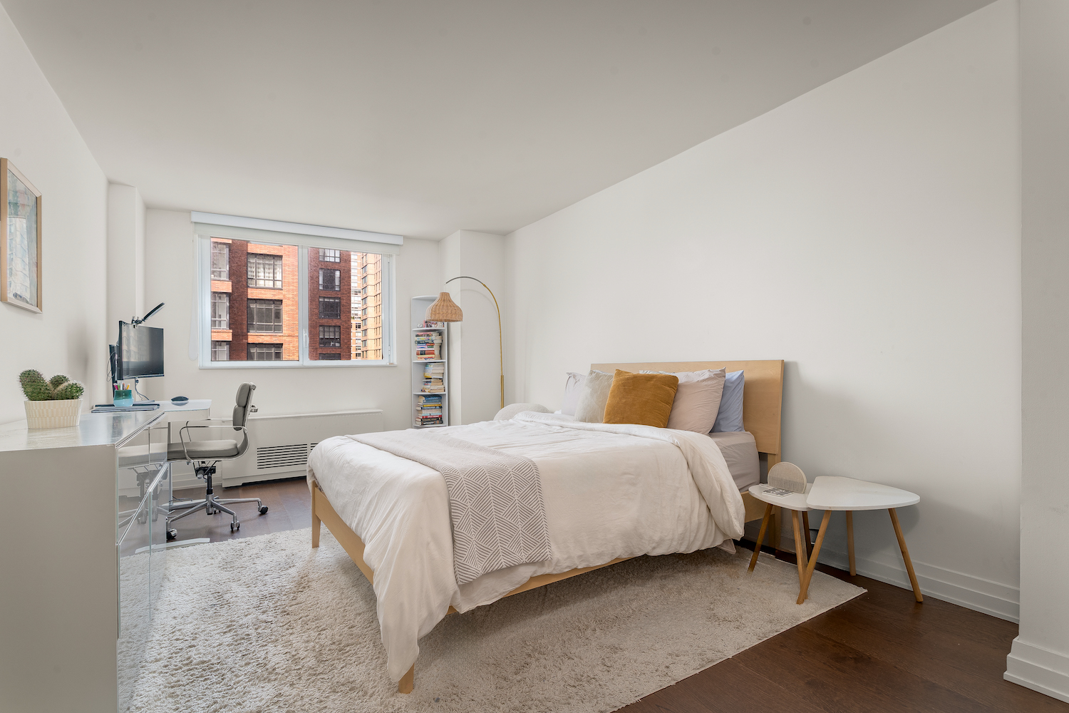 200 East 94th Street, Unit 2015 Manhattan, NY 10128 - Photo 7 of 16 a bedroom with a bed and a table