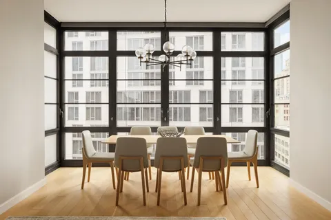 a view of a dining room with furniture and a floor to ceiling window