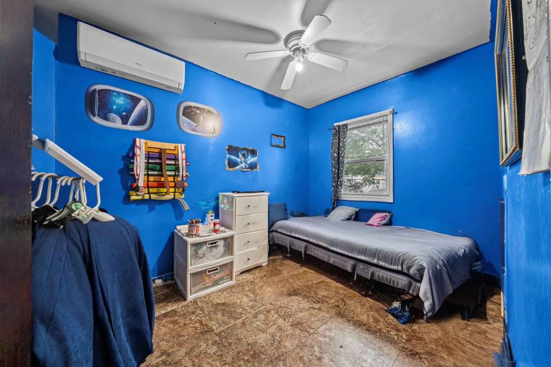 1419 East 54th Street Brooklyn, NY 11234 - Photo 11 of 19 a bedroom with furniture and a chandelier