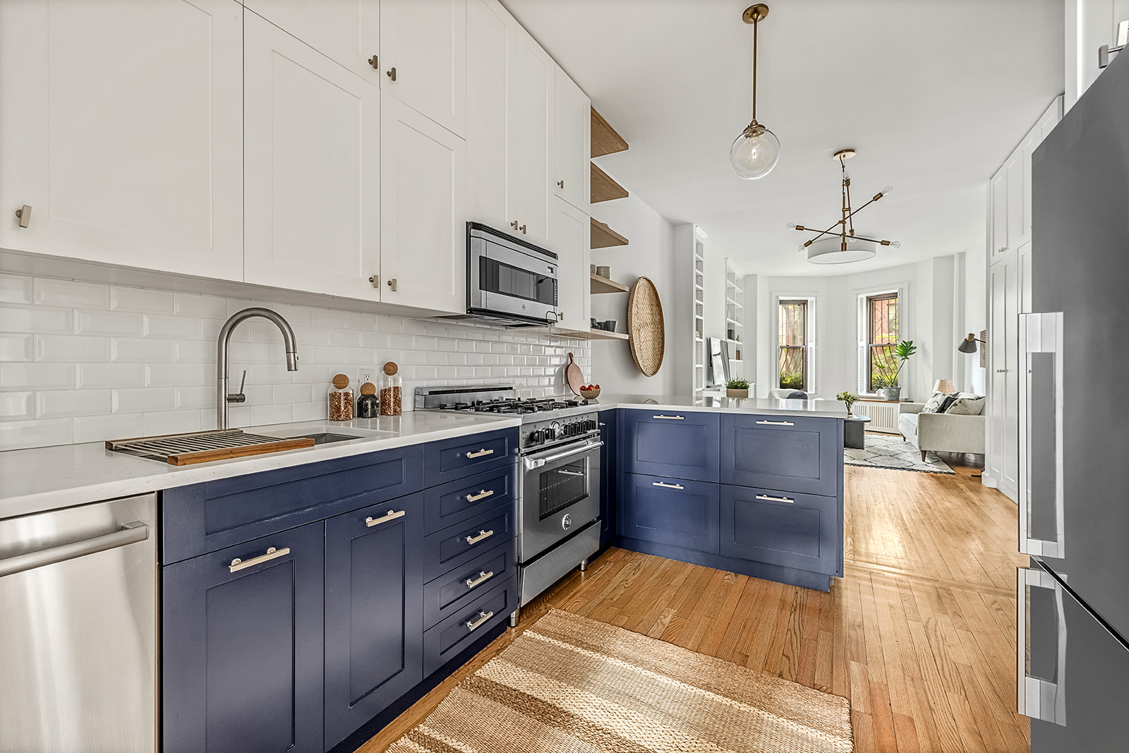 482 12th Street, Unit 1 Brooklyn, NY 11215 - Photo 2 of 10 a large kitchen with stainless steel appliances granite countertop a stove a sink dishwasher and a refrigerator with wooden floor
