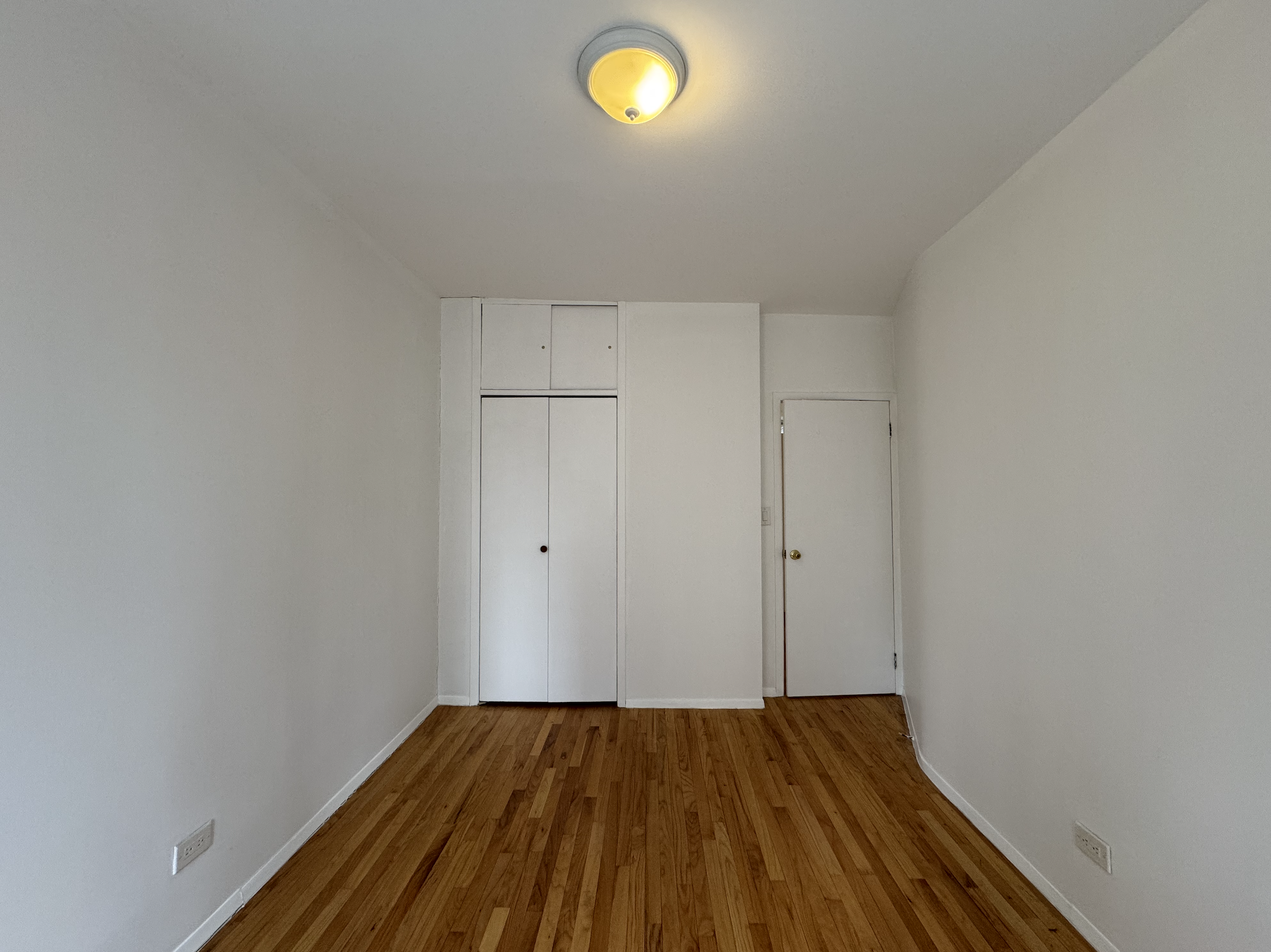 451 West 44th Street, Unit 63 Manhattan, NY 10036 - Photo 7 of 31 a view of a room with wooden floor and fan