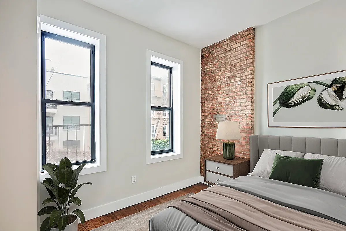 285 Cornelia Street, Unit 3R Brooklyn, NY 11221 - Photo 5 of 10 a bedroom with a bed and a potted plant next to a window