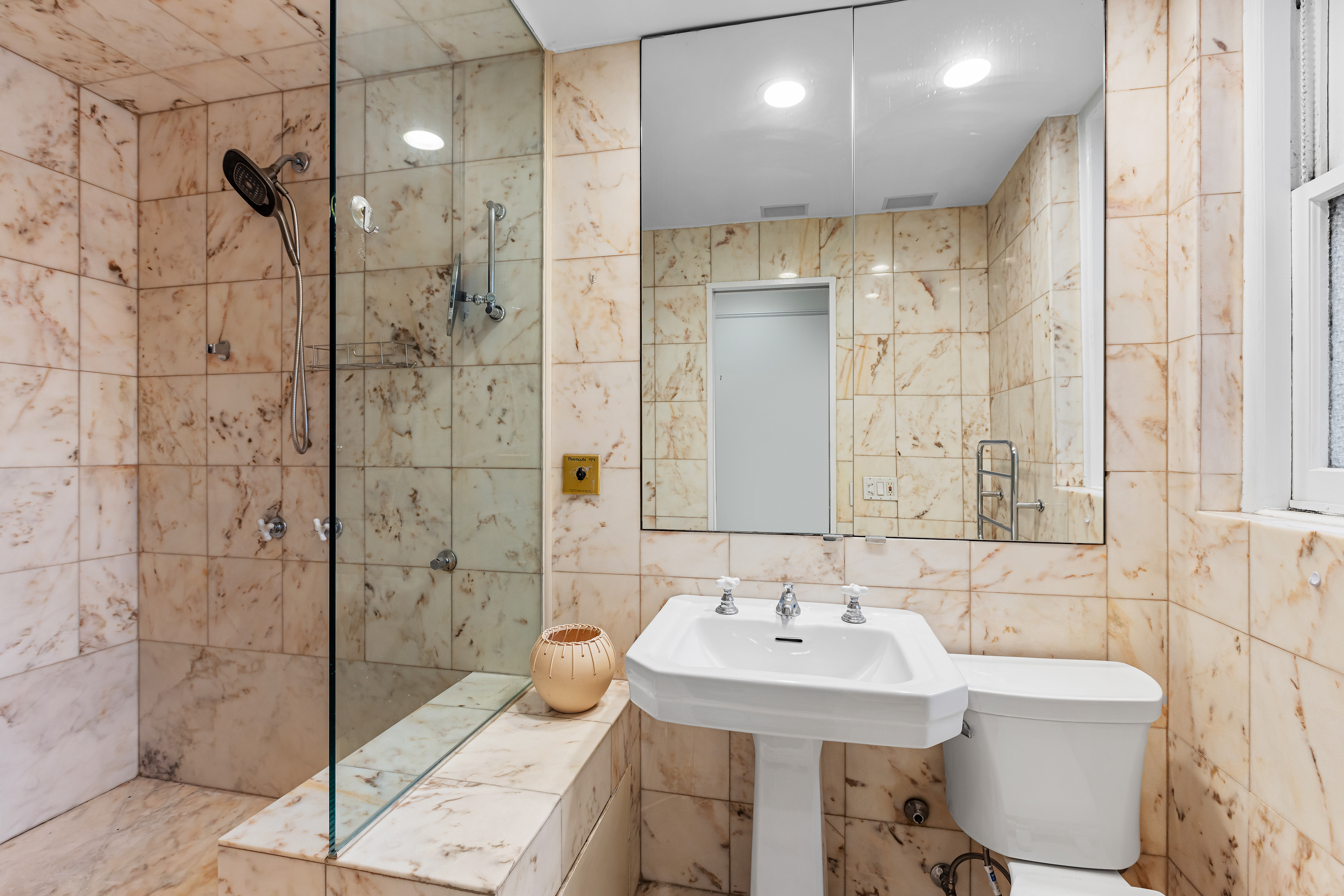 25 East 86th Street, Unit 1C Manhattan, NY 10028 - Photo 12 of 18 a bathroom with a sink shower and a mirror