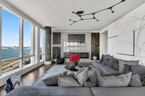 a living room with furniture fireplace and flat screen tv