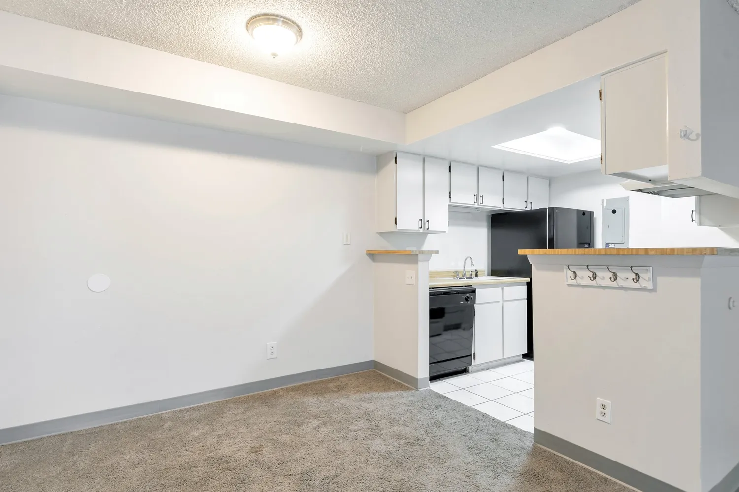 a kitchen with a refrigerator a stove top oven and cabinets