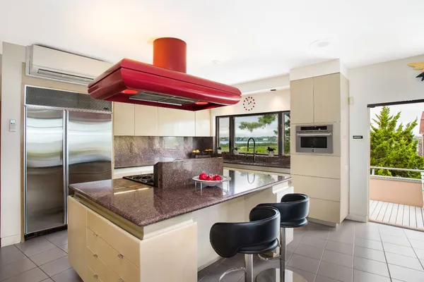 a kitchen with stainless steel appliances granite countertop a sink and a refrigerator