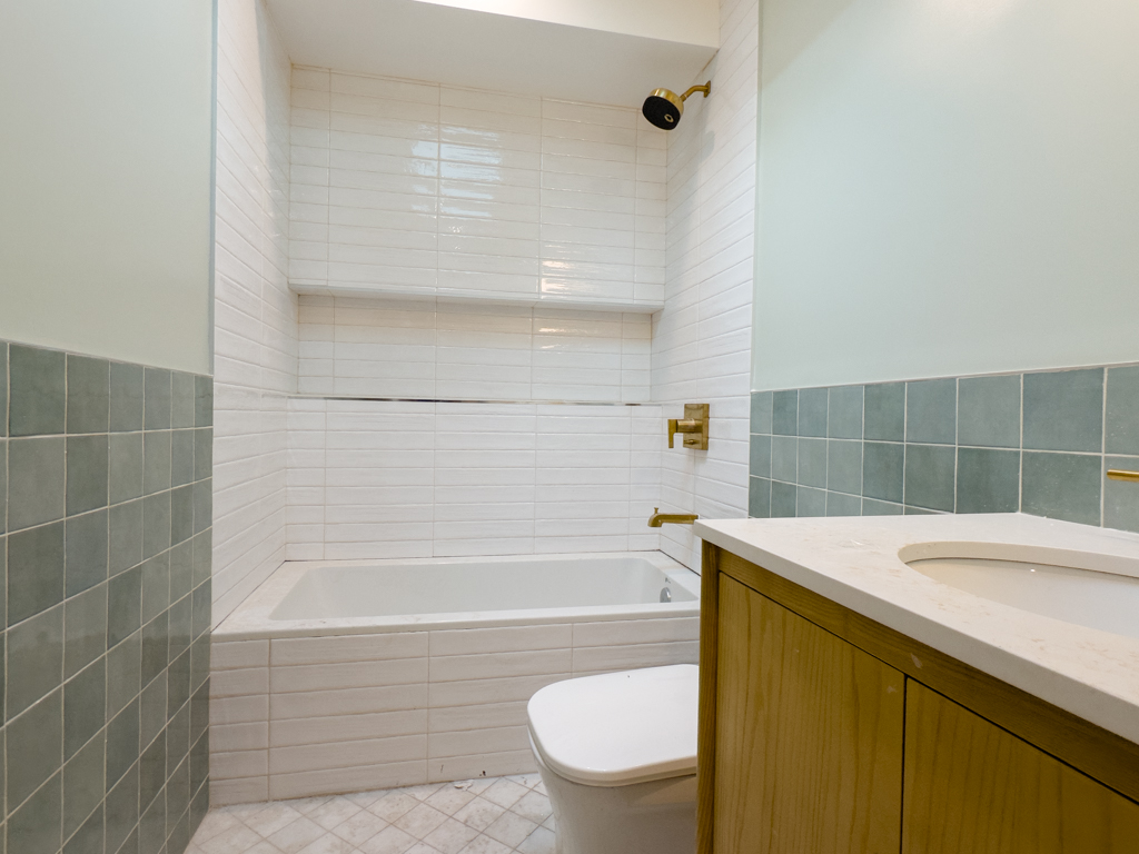 795 Quincy Street Brooklyn, NY 11221 - Photo 14 of 17 a bathroom with a sink a toilet and bathtub