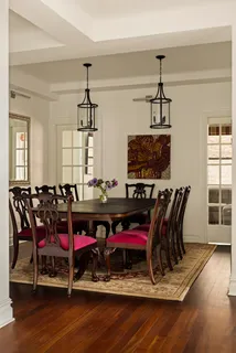 a view of a dining room with furniture wooden floor and chandelier