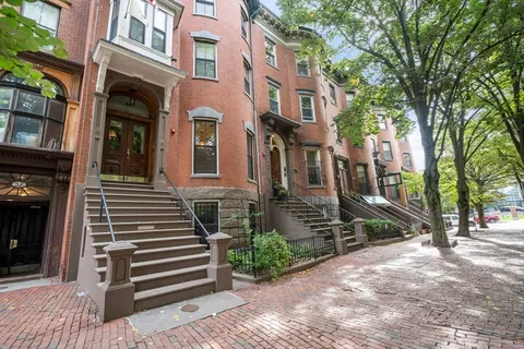 an aerial view of a residential apartment building with a yard