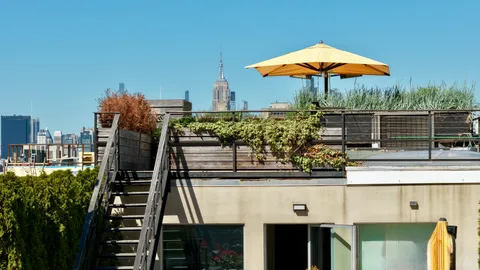 a view of a balcony with an umbrella and a fireplace