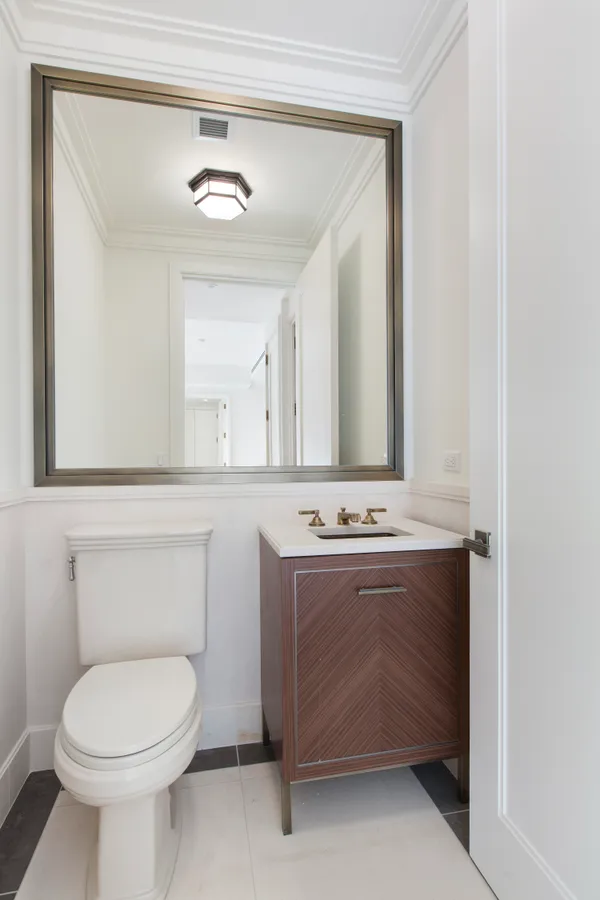 a bathroom with a sink a toilet and mirror