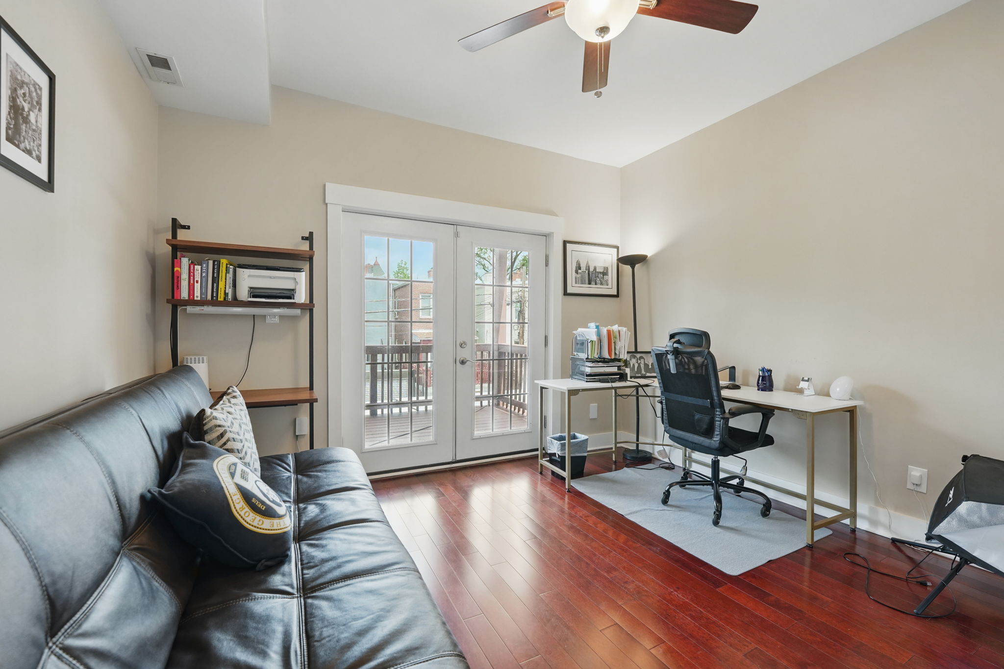 28 Q Street Northeast, Unit 2 Washington, DC 20002 - Photo 14 of 41 a livingroom with workspace and a couch