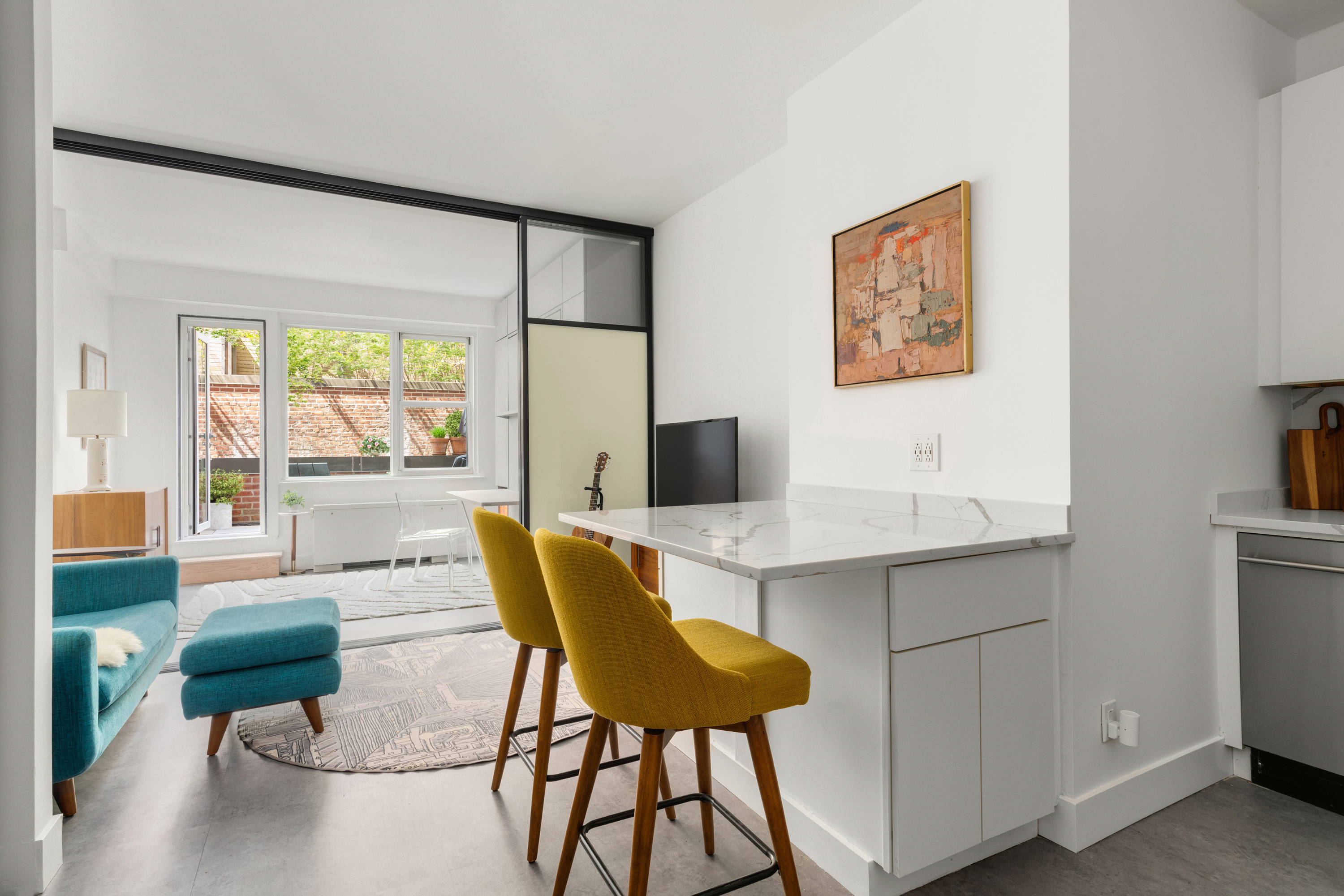 40 Clinton Street, Unit 1M Brooklyn, NY 11201 - Photo 2 of 8 a workspace with furniture and a large window