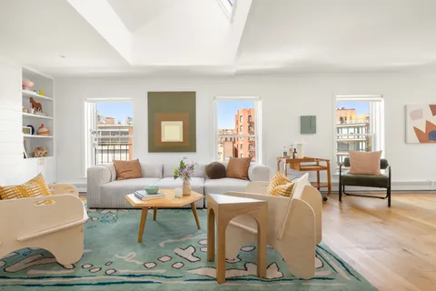 a living room with furniture dining table and a window
