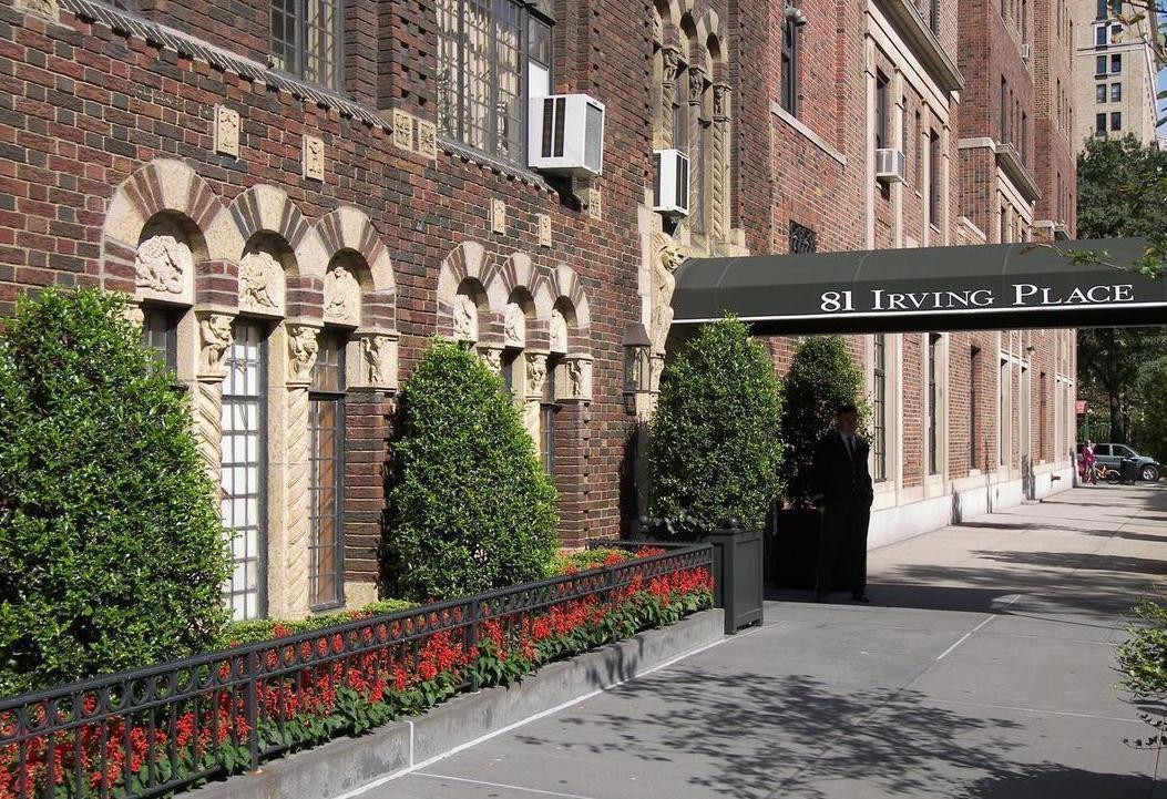 81 Irving Place, Unit 15DE Manhattan, NY 10003 - Photo 15 of 18 a street view with tall buildings and a street sign on a wall