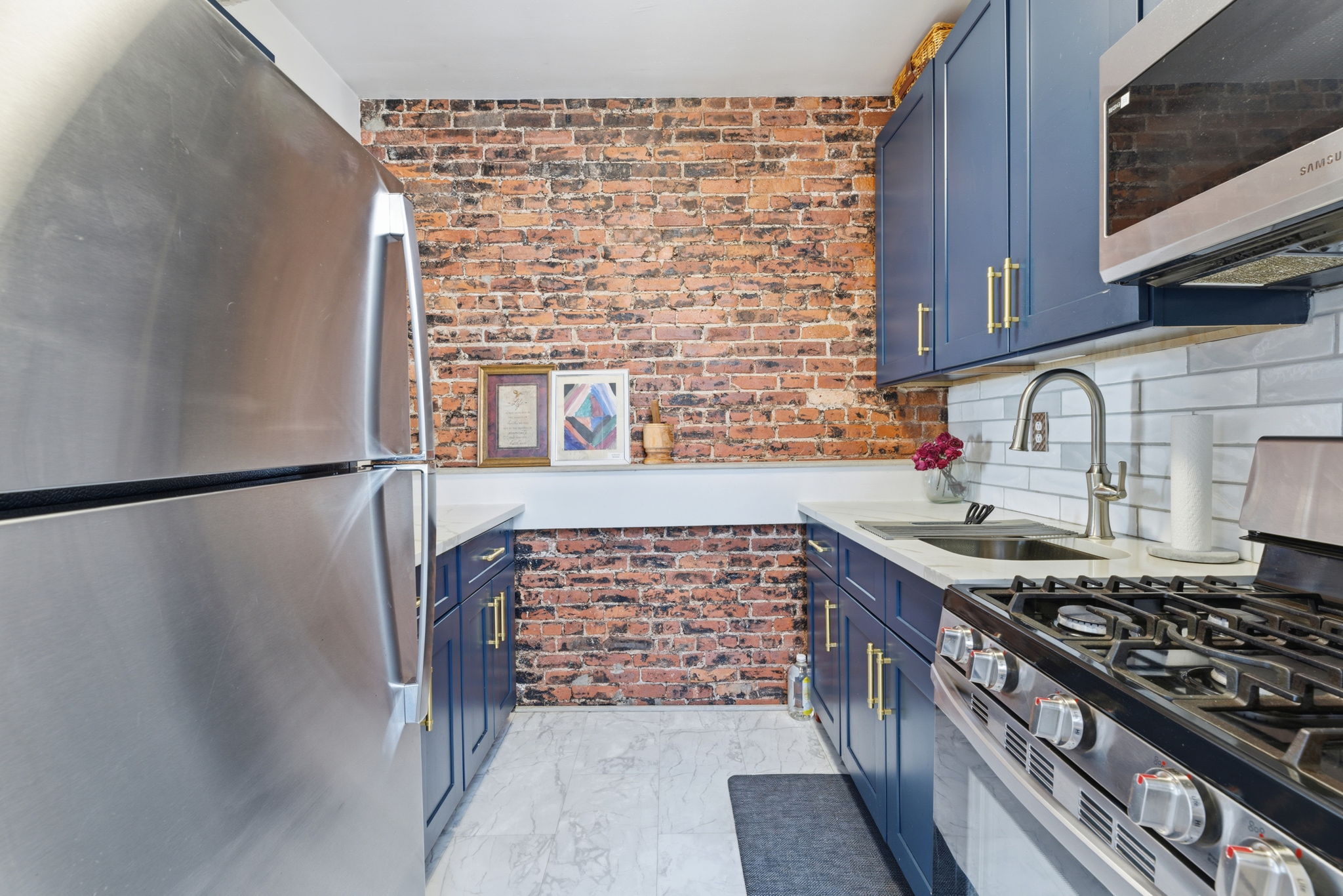 436 Chauncey Street, Unit 4 Brooklyn, NY 11233 - Photo 5 of 7 a kitchen with a stove and a refrigerator