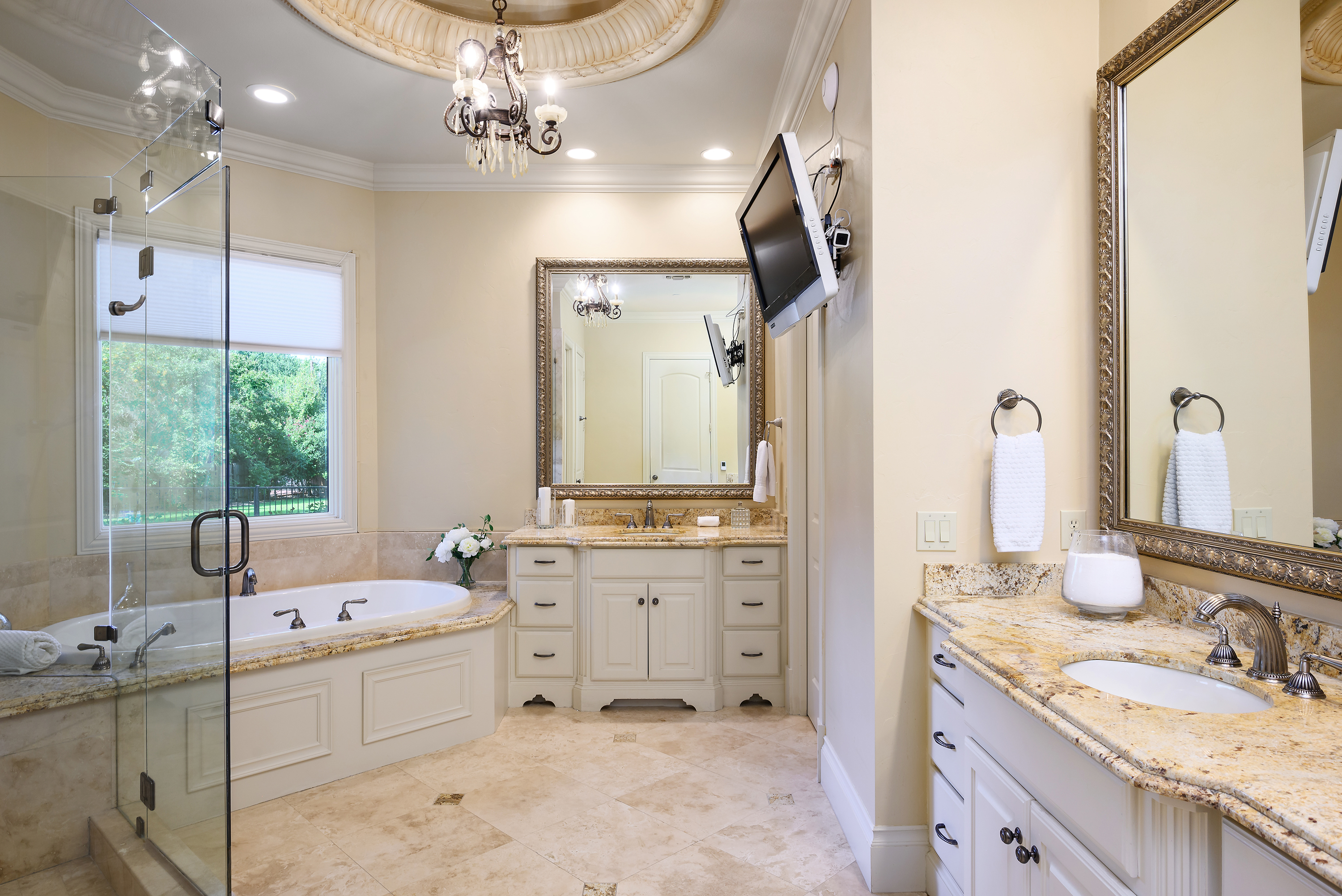 11503 West Ricks Circle Dallas, TX 75230 - Photo 23 of 39 a bathroom with a granite countertop sink a large mirror and a bathtub