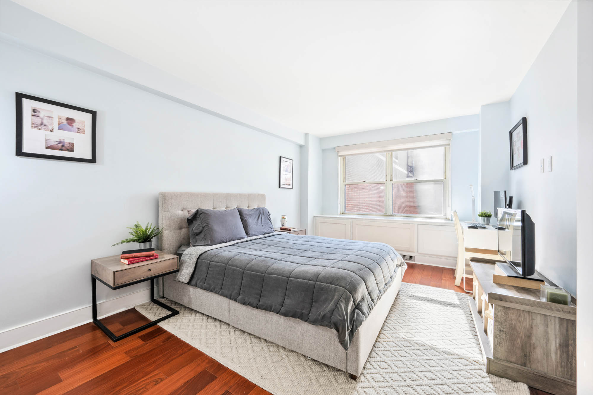 420 East 72nd Street, Unit 2J Manhattan, NY 10021 - Photo 6 of 12 a bedroom with a bed and wooden floor