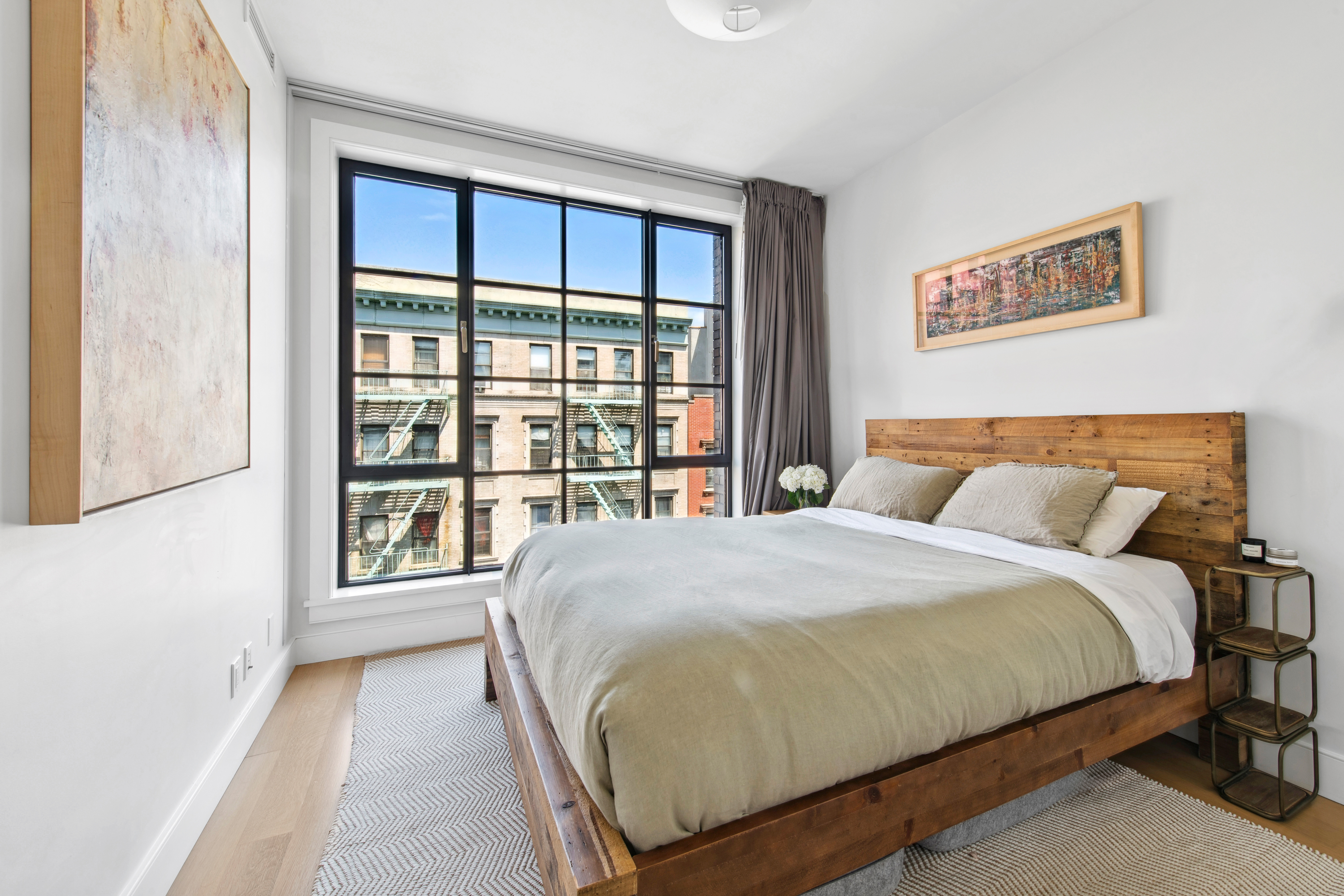 536 East 13th Street, Unit 5F Manhattan, NY 10009 - Photo 8 of 16 a bedroom with a large bed and a large window