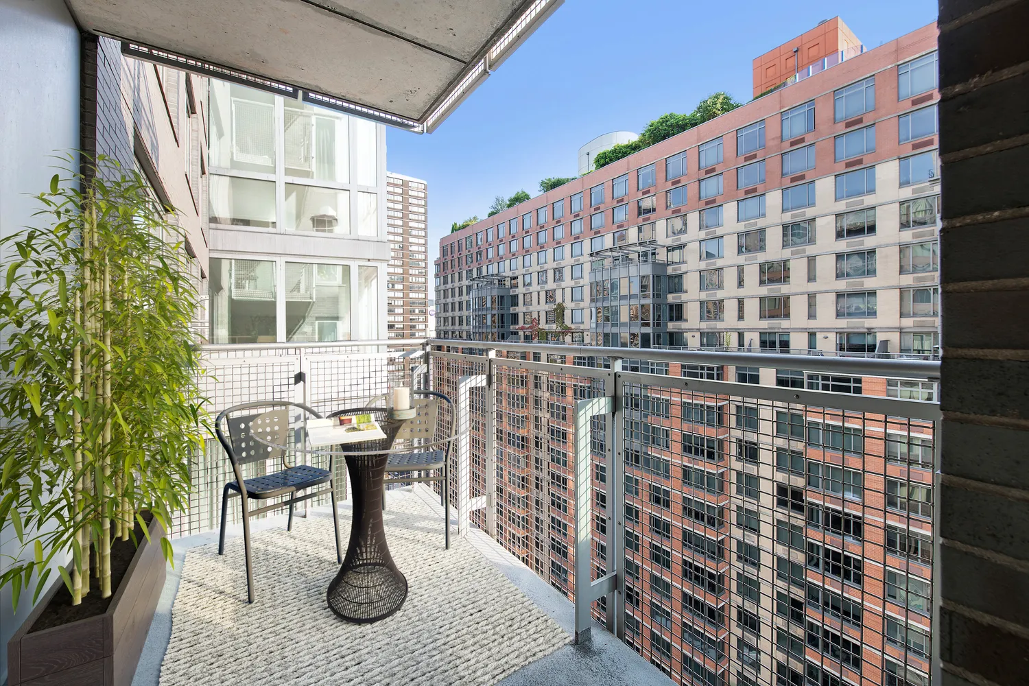 a patio with table and chairs and potted plants
