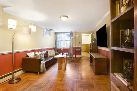 a living room with couches and a flat screen tv