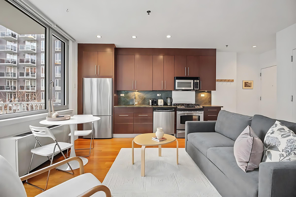 154 Attorney Street, Unit 304 Manhattan, NY 10002 - Photo 3 of 13 a living room with furniture kitchen view and a large window