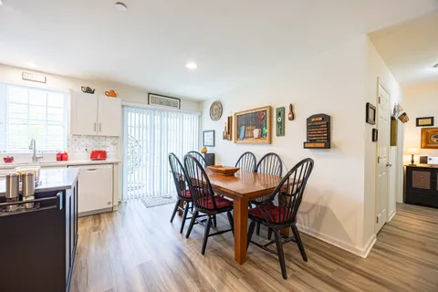 a dining room with furniture and wooden floor