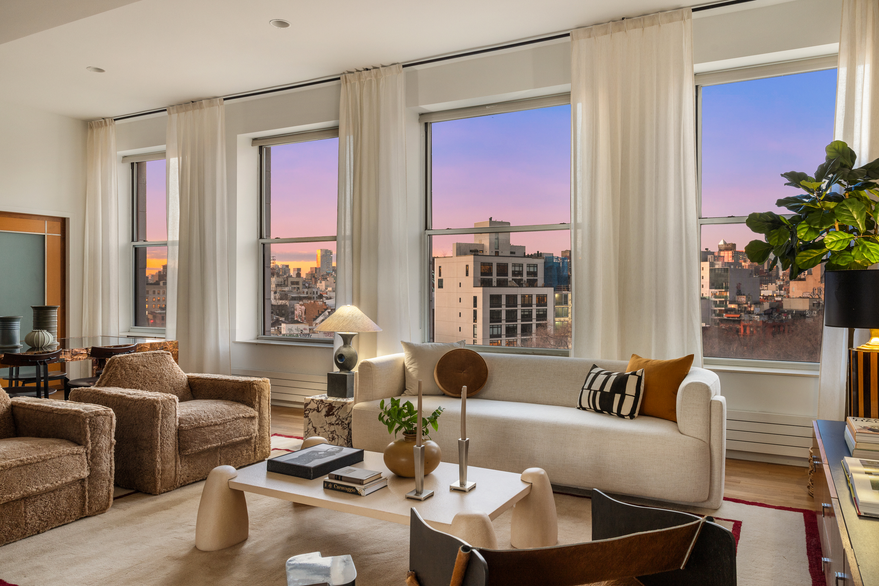 175 East Broadway, Unit 7A Manhattan, NY 10002 - Photo 2 of 24 a living room with furniture and a large window