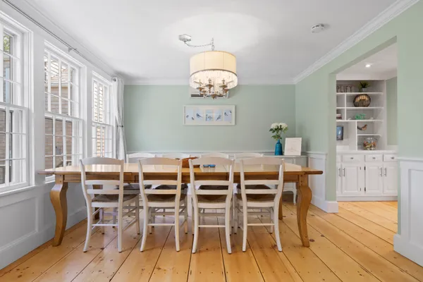 a view of a dining room with furniture and wooden floor
