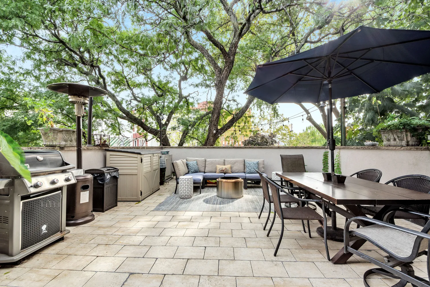 a view of chairs and table in backyard
