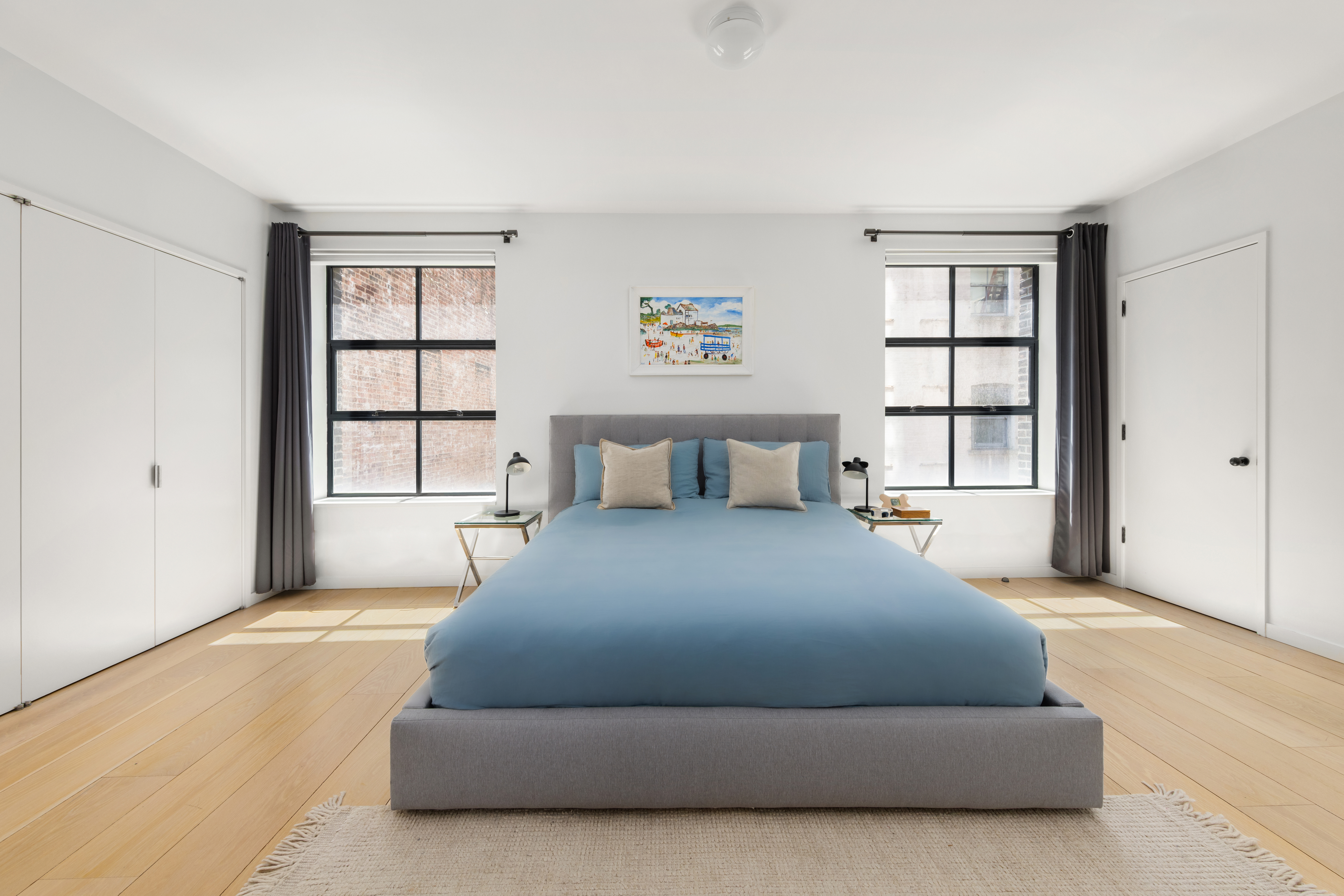 456 West 19th Street, Unit 4/5A Manhattan, NY 10011 - Photo 11 of 15 a large bed sitting in a bedroom next to a window and closet